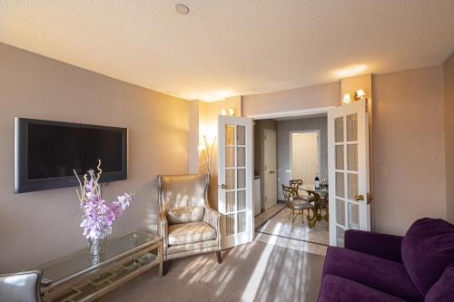 a living room with a couch and a tv at The Avenue Plaza in Brooklyn