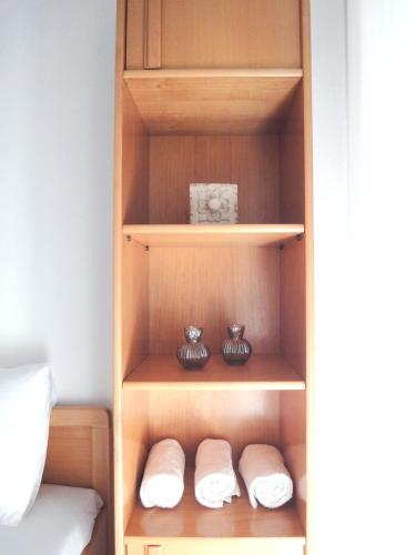 a closet with two towels and two vases at Polychrono Nikos Apartment in Polychrono