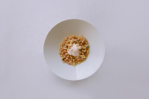 a doughnut on a white plate on a table at Hotel El Cid in Morella