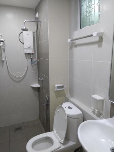 a bathroom with a toilet and a sink at D'Perdana Apartment 2 in Kota Bharu