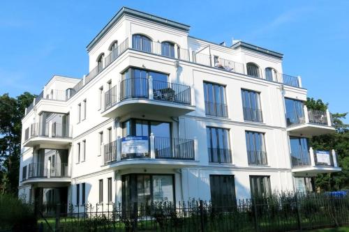 a white building with balconies on the side of it at "Bellevue" Villa Andrea in Baabe