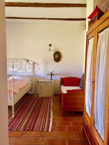 a bedroom with a bed and a couch at Mala Kmetija in Slovenske Konjice