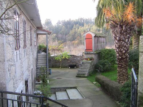 a house with a red door and a palm tree at Casa Xan da Pena in Villarmayor