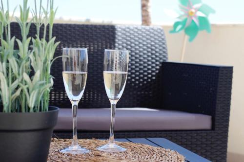 two glasses of champagne are sitting on a table at RiaMar - Praia da Vagueira in Gafanha da Vagueira