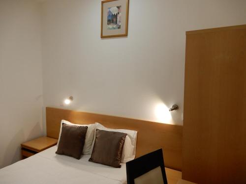 Postel nebo postele na pokoji v ubytování Guesthouse Coimbra City
