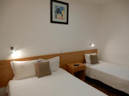 Postel nebo postele na pokoji v ubytování Guesthouse Coimbra City