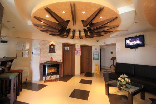 a living room with a large chandelier and a fireplace at Mountview Lodge Apartments in Bansko