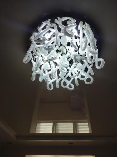 a chandelier hanging from a ceiling in a room at Квартира in Tiraspol