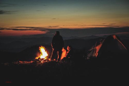 a person standing next to a camp fire at Sadyba Pikuy in Bilasovytsya