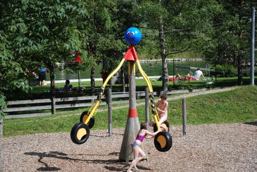 two children playing on a playground in a park at Ferienwohnung Pension Tirol in Bichlbach