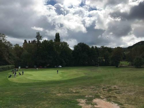 a group of people playing golf on a field at Manoir de Rieuzal in Loubressac