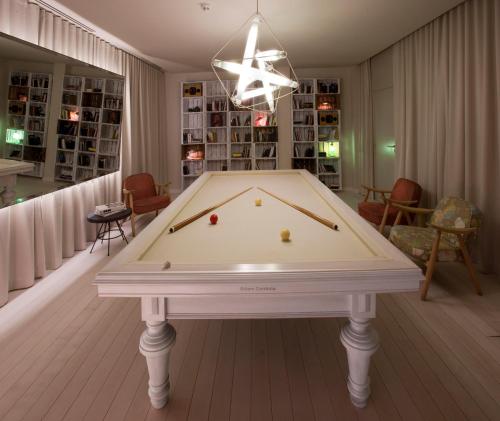 a pool table in a living room with ahibition at Sixties Ramblas in Barcelona