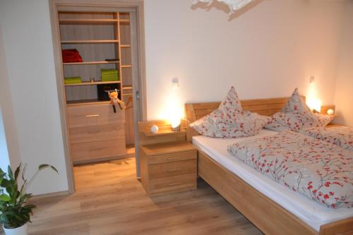 a bedroom with a bed with pillows on it at Eifelgold in Habscheid