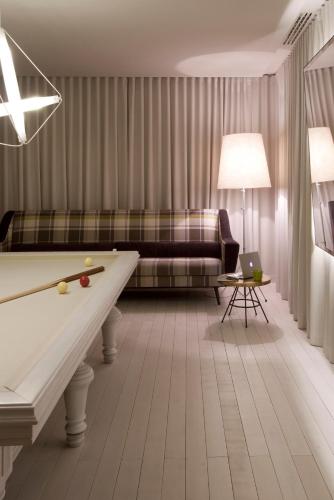 a living room with a pool table and a couch at Sixties Ramblas in Barcelona