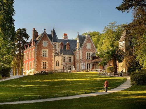 une femme s'engageant sur un chemin devant une grande maison dans l'établissement Jodelle, à La Riche