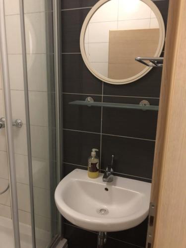a bathroom with a sink and a mirror at Apartmani Ancora in Neum