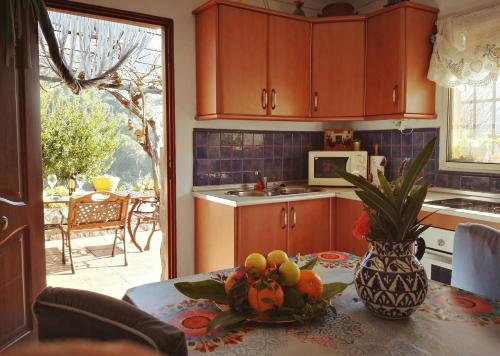 a kitchen with a table with a vase of fruit on it at Cortijo Buenavista in Málaga