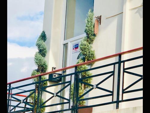 a door with plants on the side of a building at Lovely Apartments in Patra