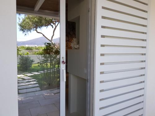 a door leading out to a patio with a view at Casa Mirella in Favignana
