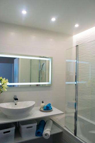 a bathroom with a sink and a glass shower at Dream park in Montévrain