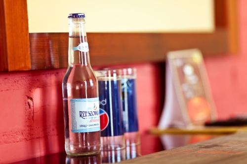 a bottle of soda sitting on top of a counter at Dwa Bratanki in Rzeszów