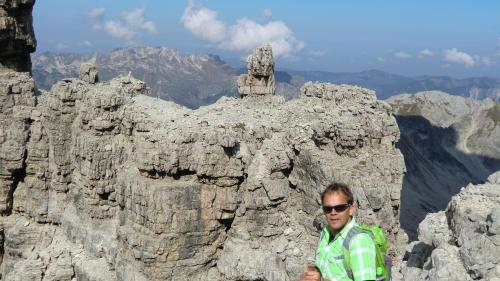 a man standing in front of a rocky mountain at Ferienwohnung Allgäuer Landhaus Stocker in Hopferau-Füssen in Hopferau