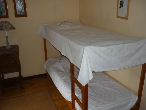 two bunk beds in a room with a night stand at Diane Chasseresse in Soignies