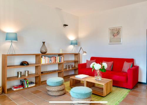 a living room with a red couch and a table at La Fornace in Alessandria