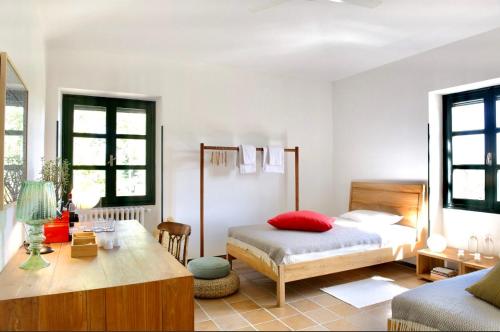 a bedroom with a bed and a table in it at La Fornace in Alessandria