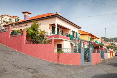 a red fence in front of a house at Casa da Maria 15 - Funchal - Famílias in Funchal
