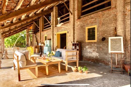 a living room with furniture and a brick wall at La Fornace in Alessandria