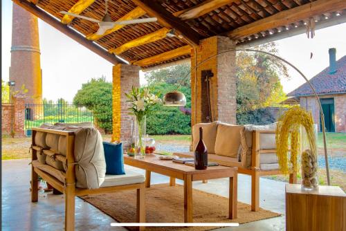 a patio with two chairs and a table at La Fornace in Alessandria