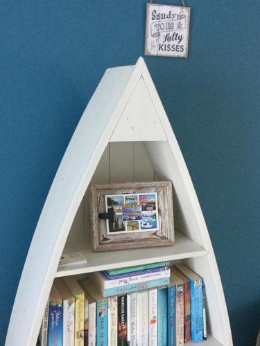 a book shelf with a picture inside of it at Beachside Apartment in Bangor