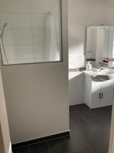 a bathroom with a sink and a mirror at Center Rooms Villach in Villach