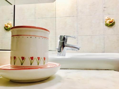 a coffee cup sitting on a counter next to a sink at Casa Santo Stefano in Bologna