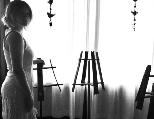 a woman in a white dress standing in front of a window at Azienda Agricola Il Querceto in Marsico Vetere