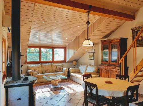 a living room with a couch and a table at Paola paradise in Forel