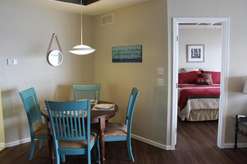a dining room with a table and chairs and a bed at Lake Ozarks Get Away in Lake Ozark