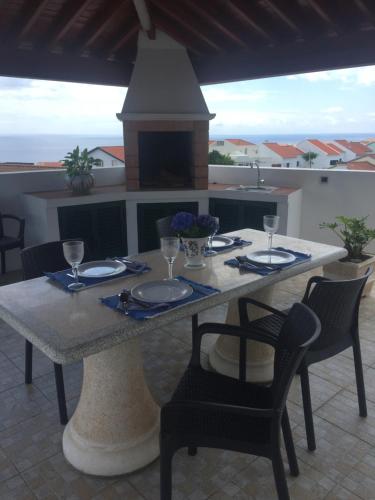 a table with plates and wine glasses on a patio at Vivenda Garcia Bed and Breakfast in Relva