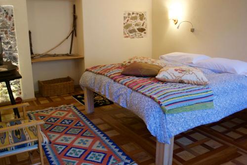 a bedroom with a bed with pillows on it at Azienda Agricola Il Querceto in Marsico Vetere