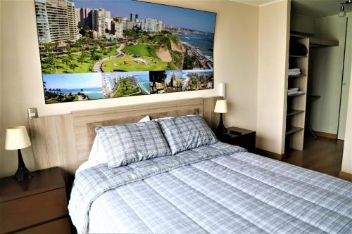 a bedroom with a bed with a large picture on the wall at Miraflores Apartments 570 Pardo Ave by Private Host in Lima