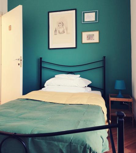 a bedroom with a bed with a blue wall at Porta Maggiore GH Locazione Turistica in Rome