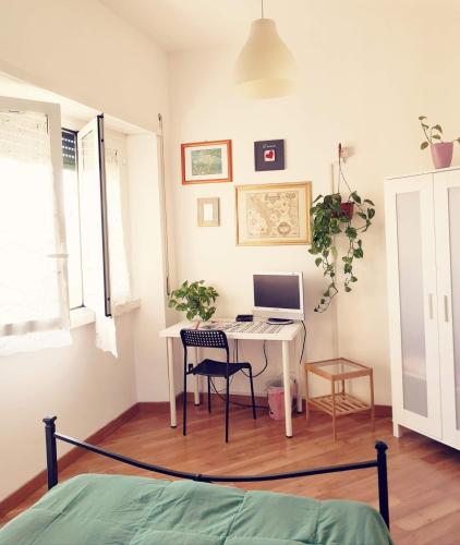 a bedroom with a desk with a computer on it at Porta Maggiore GH Locazione Turistica in Rome
