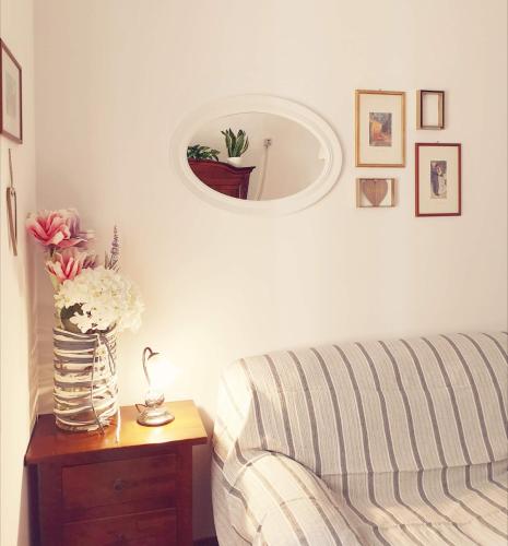 a living room with a couch and a table with a mirror at Porta Maggiore GH Locazione Turistica in Rome