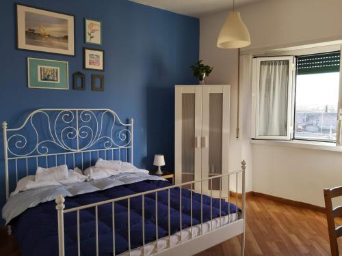 a blue bedroom with a bed with a blue wall at Porta Maggiore GH Locazione Turistica in Rome