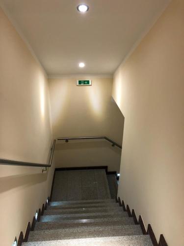 an empty stairs in a building with a sign on the wall at Center Rooms Villach in Villach