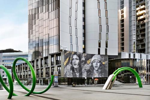 a city street with graffiti on the side of it at Peppers Docklands in Melbourne