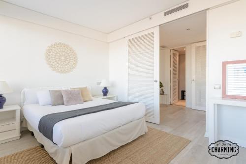 a white bedroom with a bed and a fireplace at Charming Eurobuilding 2 Luxury in Madrid