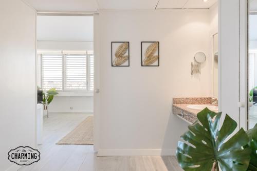 a bathroom with white walls and a potted plant at Charming Eurobuilding 2 Luxury in Madrid
