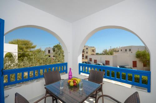 a balcony with a table with fruit on it at Hotel Francesca in Agios Prokopios